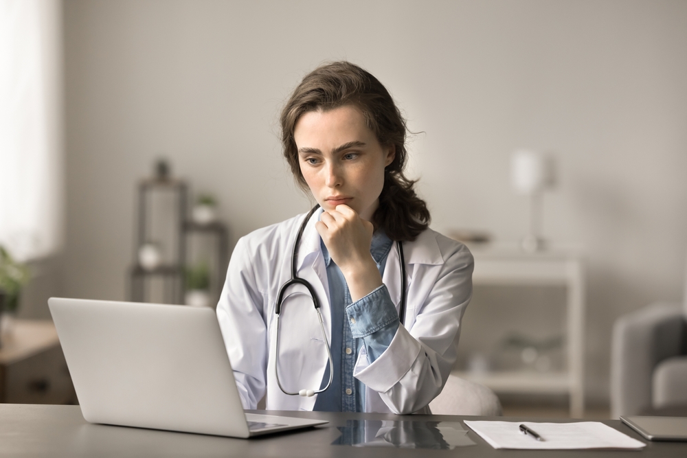 Médico perito a analisar registos clínicos para avaliação de sequelas após acidente de trabalho